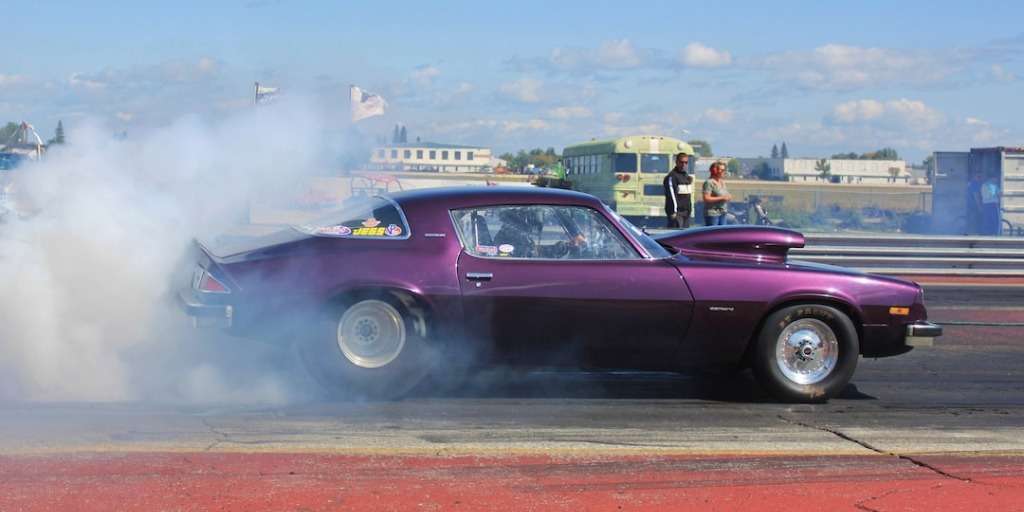 Track Racing Drag Races: A thrilling spectacle of speed and precision. (Alternative Image: A drag race car revving at the starting line.