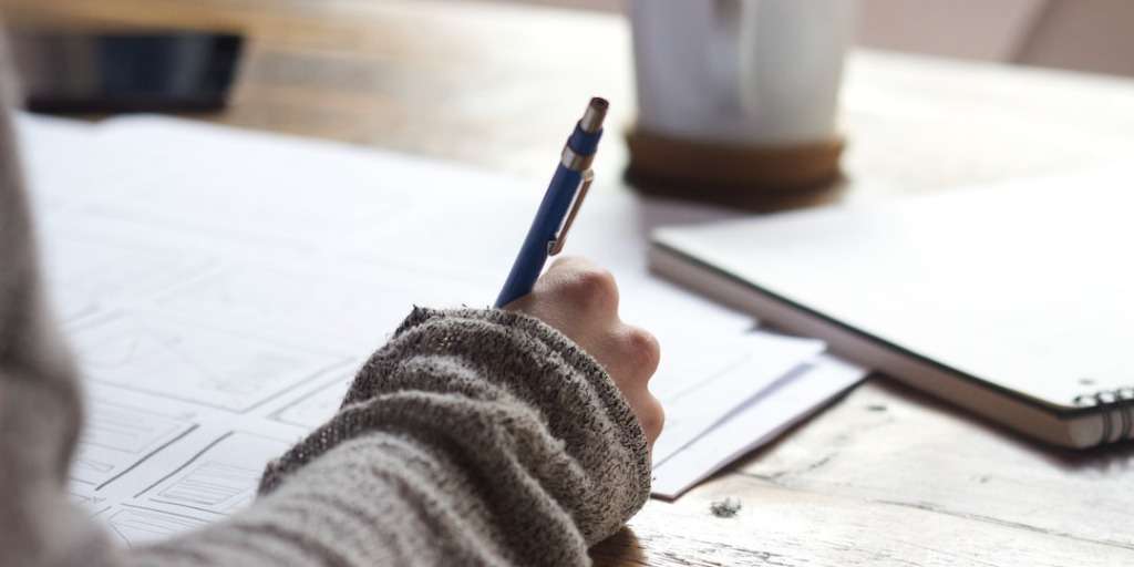 Student diligently preparing for their History P1 exam, jotting down notes and strategies on paper.