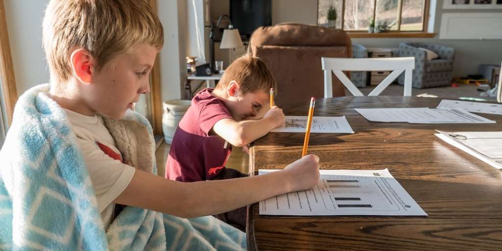 Two children engaged in a learning session at a home setting, exemplifying the personalized and flexible educational environment.