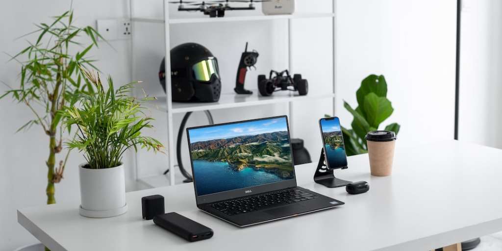 Modern tech gadgets on a desk, perfect gifts for tech lovers, with plants for decor.