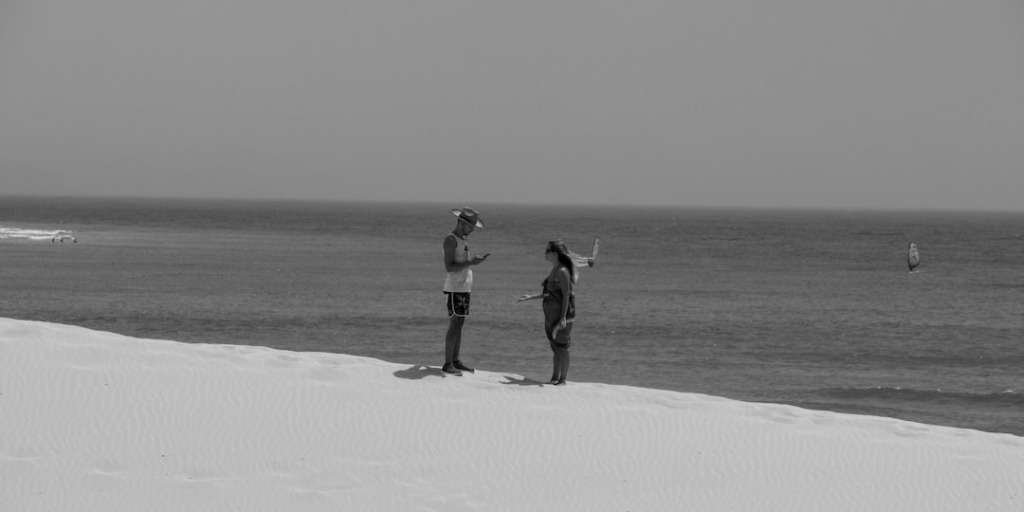 Two individuals converse on a snowy shore, a serene backdrop for strategies to win any argument.