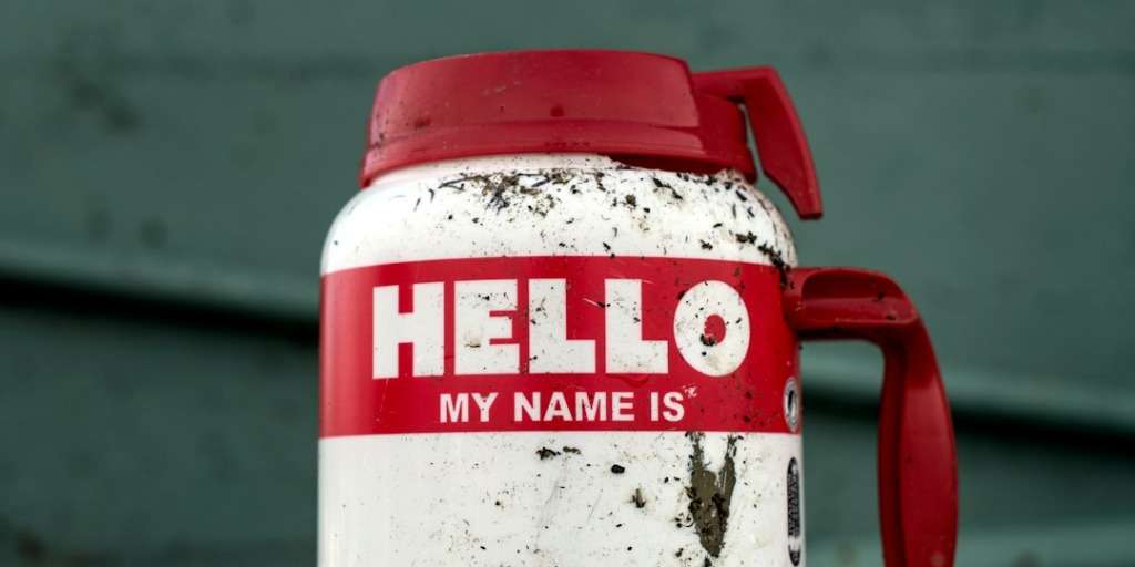 A dirty white mug with "HELLO MY NAME IS" text, evoking discussions on ugly nicknames.
