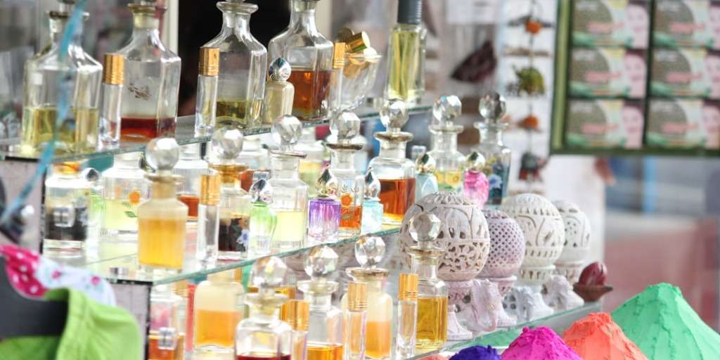Perfume bottles arrayed on a shelf, learn How to Find Out the Scent That Is Best for You with various options.