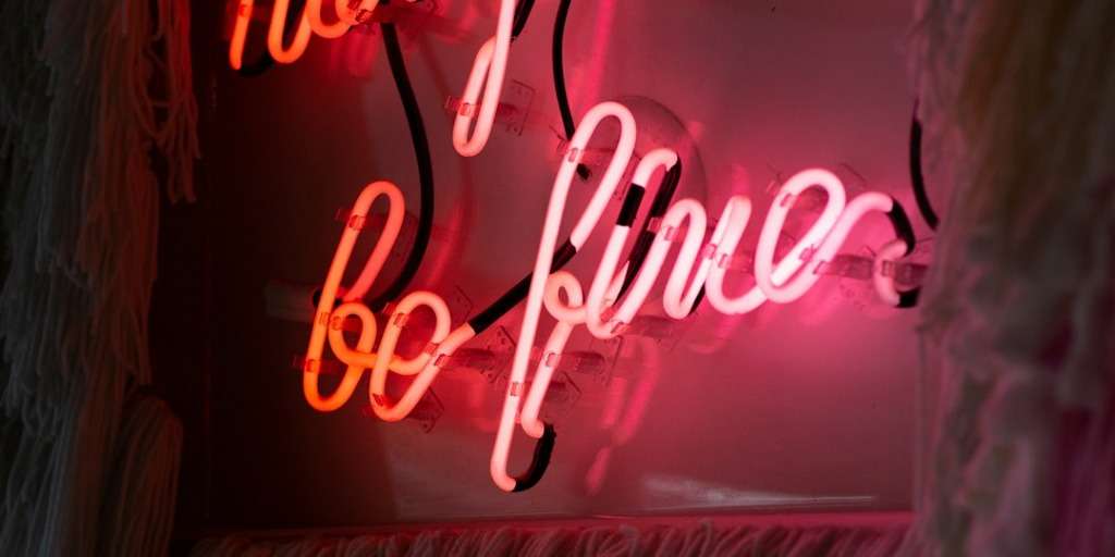 positive affirmations on a bright neon sign