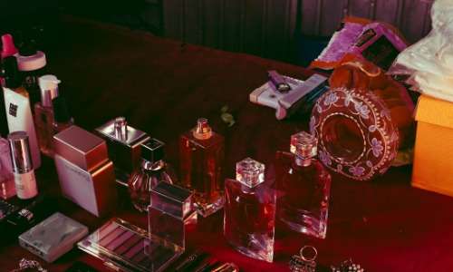 Multiple perfume bottles, representing consumerism.